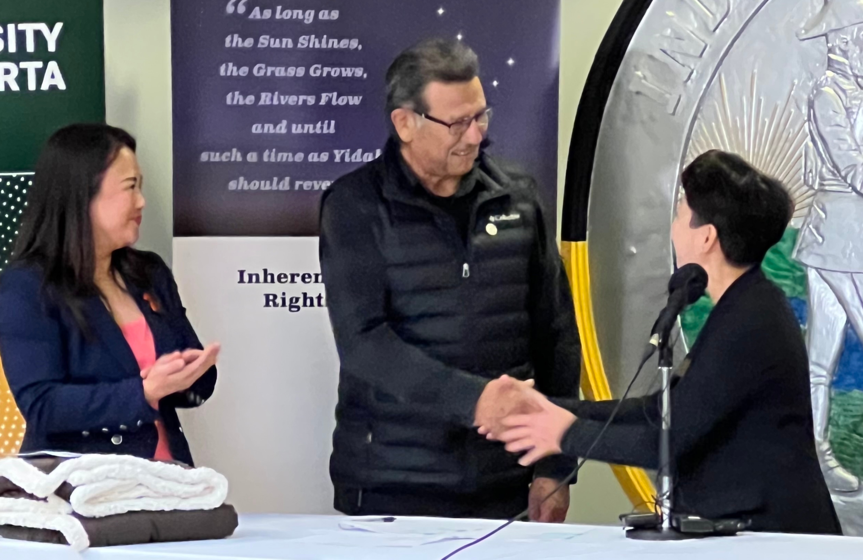 Verna Yiu, the U of A’s Interim Provost and Vice-President (Academic) and Billy Joe Laboucan, Grand Chief of Education for the Treaty 8 First Nations of Alberta, shake hands after signing the historic agreement. (Photo credit: Treaty 8 First Nations)