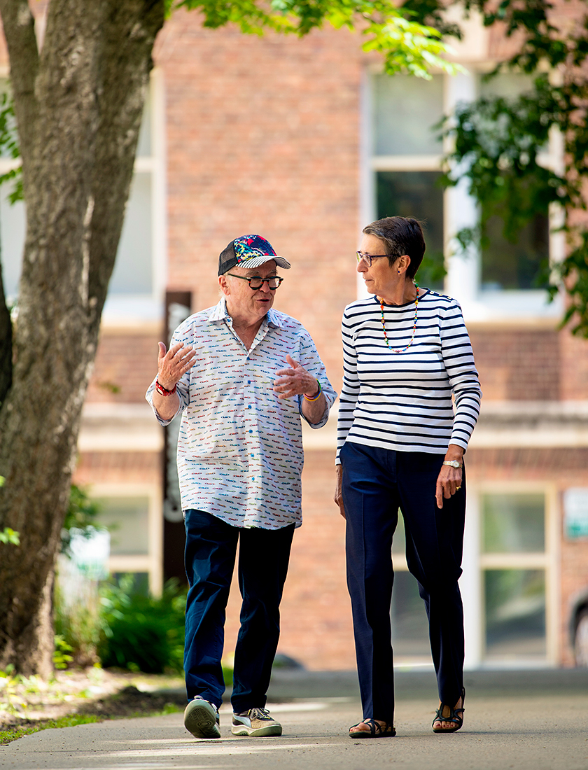 Photo of Barbara Romanowski and Michael Phair walking on campus