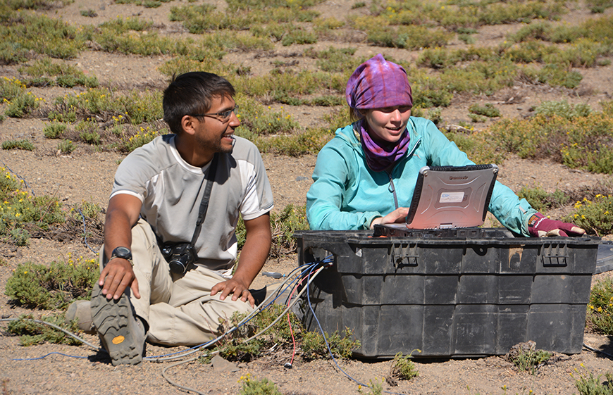 Darcy Cordell and Valentina Reyes recording geophysical data at the Laguna del Maule volcanic field in Chile in February 2016. This is a restless volcano with the surface moving upwards at 30 cm per year due to injection of magma at depth. The magnetotelluric instrument being used in the photo allows researchers to develop an image of the subsurface distribution of molten rock and hot water. Photo by Martyn Unsworth.