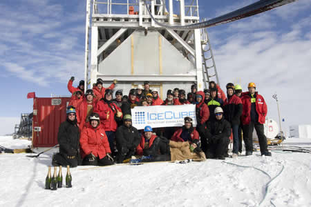 Researchers celebration the completion of the IceCube Neutrino Observatory in 2010.