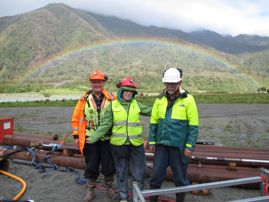 Professor Doug Schmitt, graduate student Deirdre Mallyon, and drilling engineer Alex Pyne at the Deep Fault Drilling Project rig site in New Zealand after successful testing of the system to make permeability and stress measurements. (Photo supplied by Doug Schmitt, University of Alberta.)