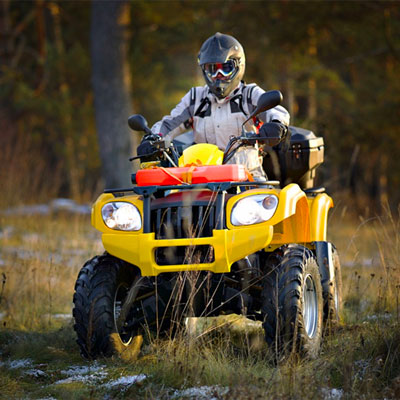 Person riding an all terrain vehicle (ATV) outdoors