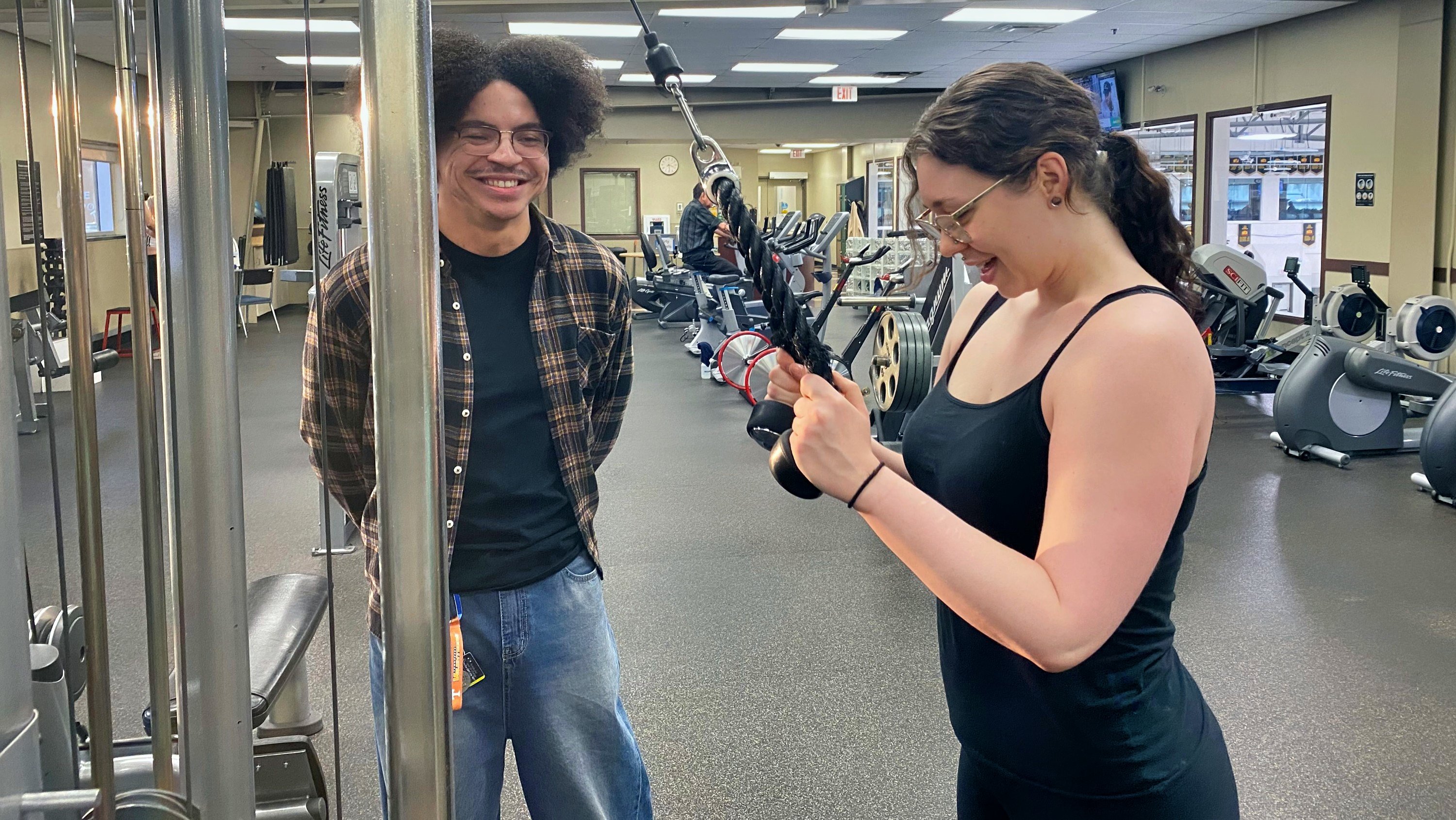 Student volunteer Delton Owens (left) assists an Indigenous Wellness Clinic client with weight training at the Saville Community Sports Centre. (Photo: Jennifer Fitzgerald)