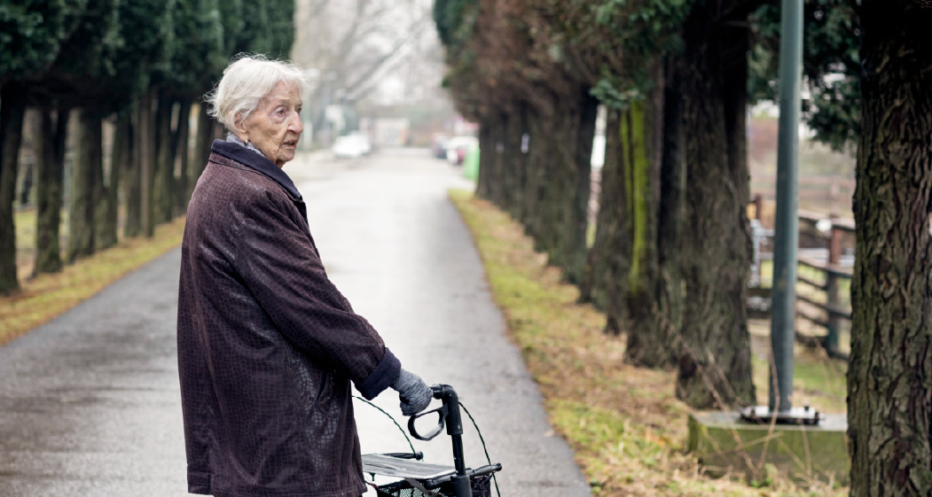 A senior woman looking back from her walk