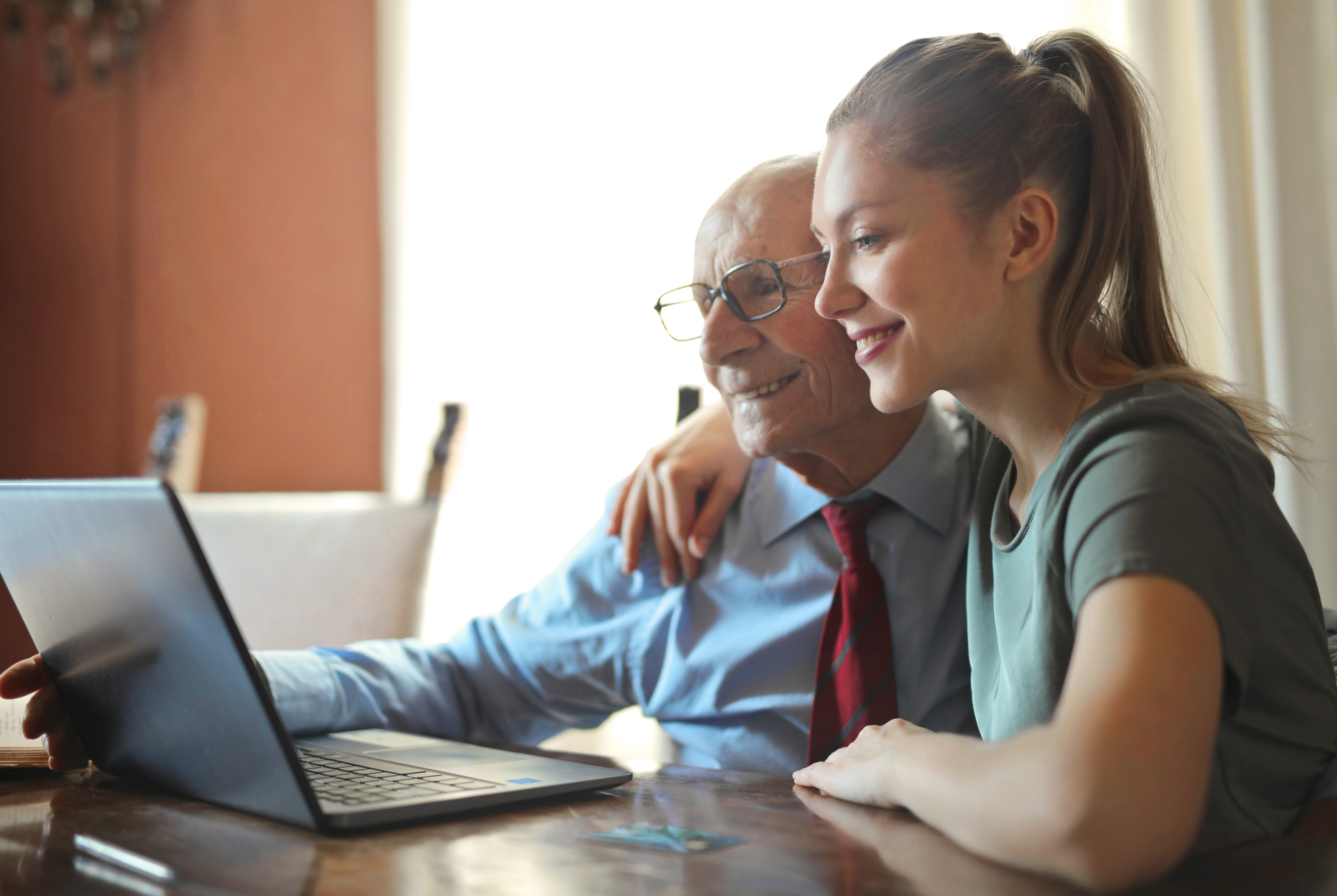 young-positive-woman-helping-senior-man-using-laptop-3823489.jpg