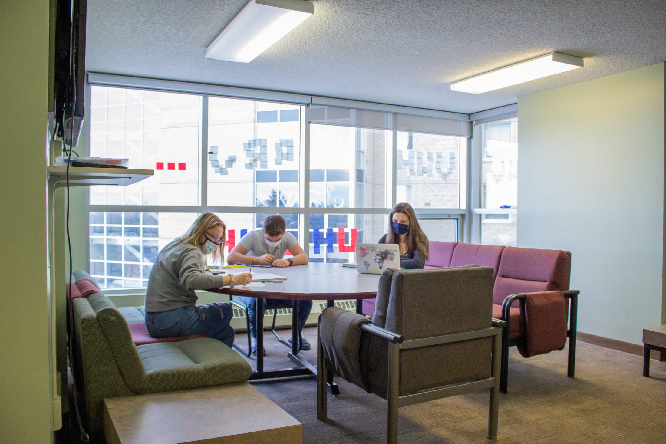 Students studying together around a table in residence