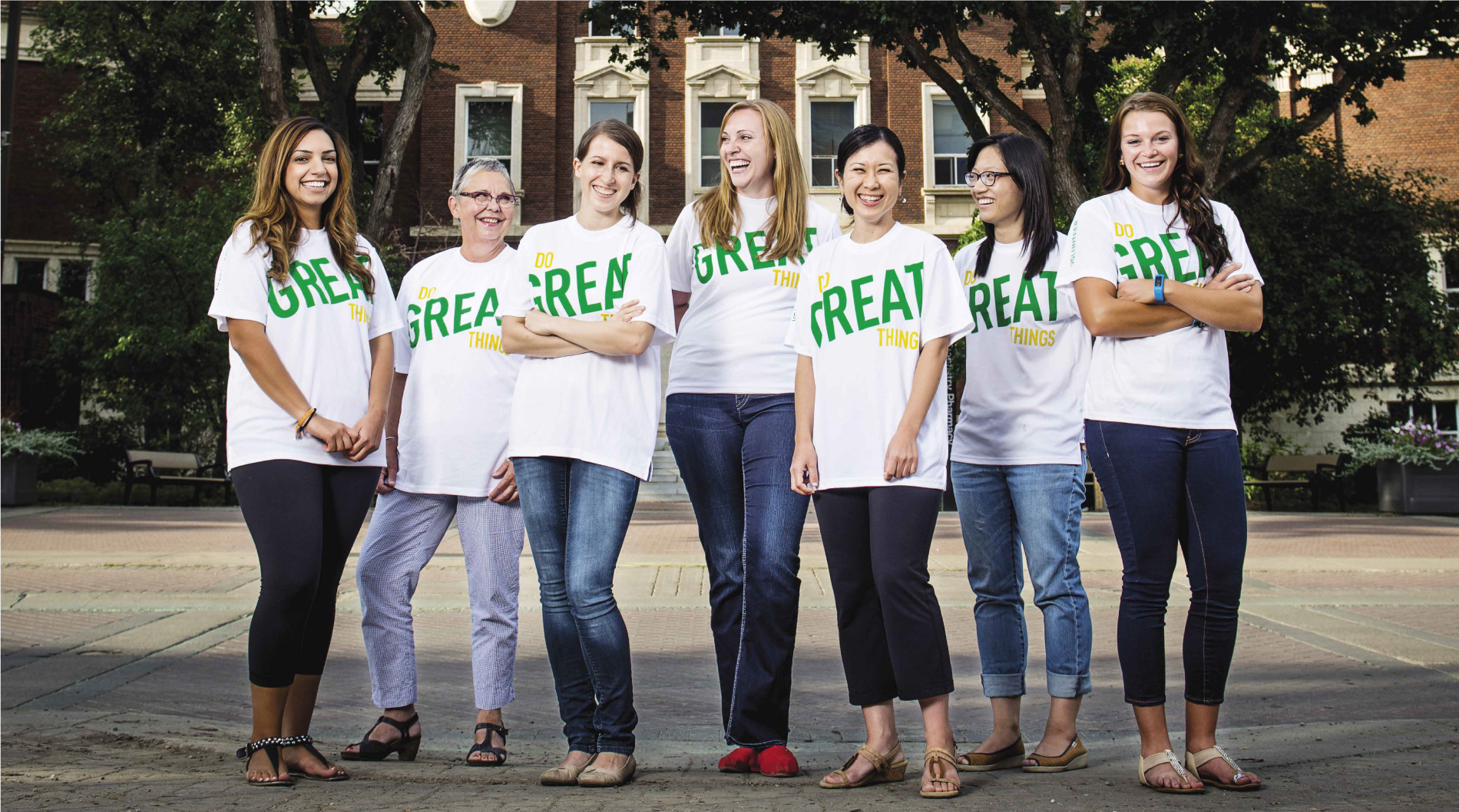 Group of alumni standing in a row wearing Do Great t-shirts
