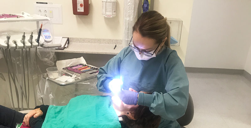 Brooke working on a patient
