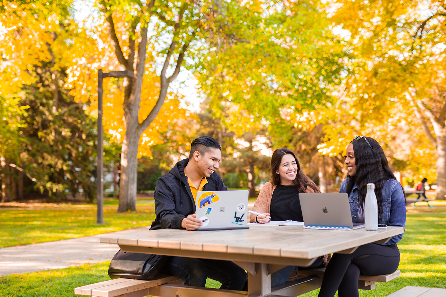 Students sitting at a table on campus