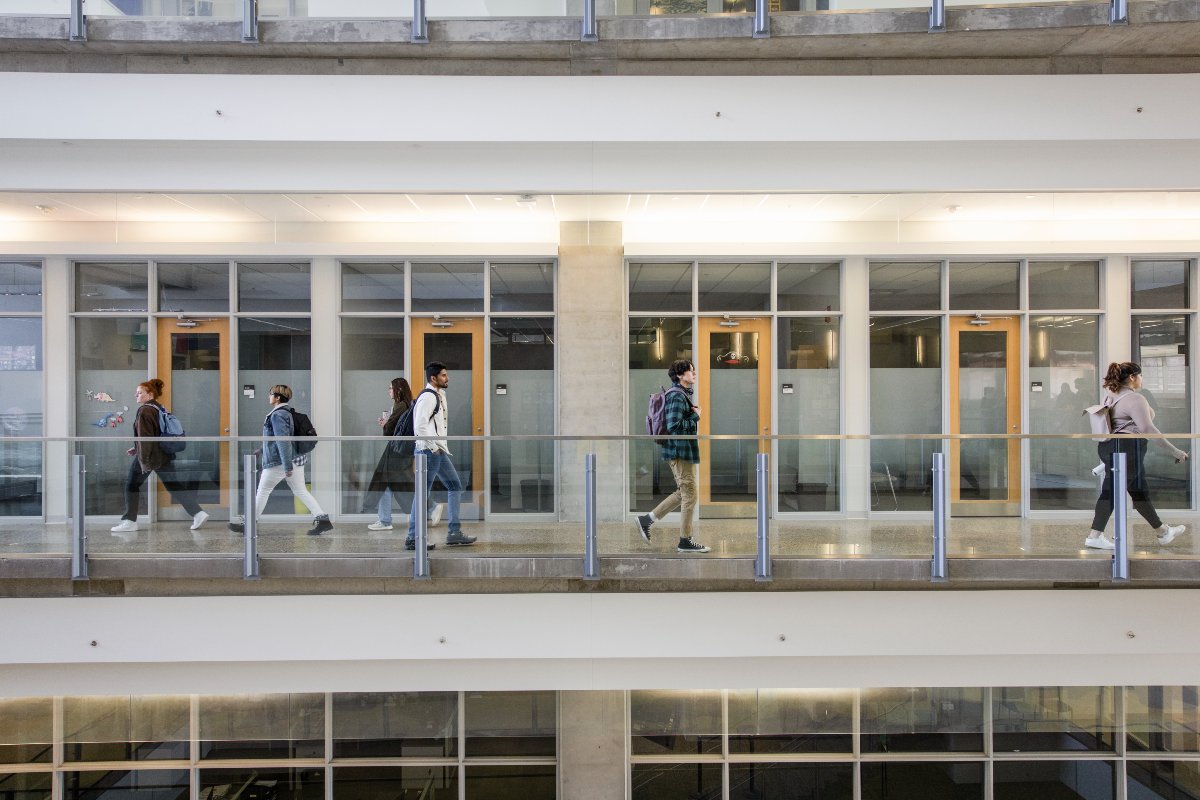 A group of Faculty of Science students walk between labs in the Centennial Centre for Interdisciplinary Science at the University of Alberta.