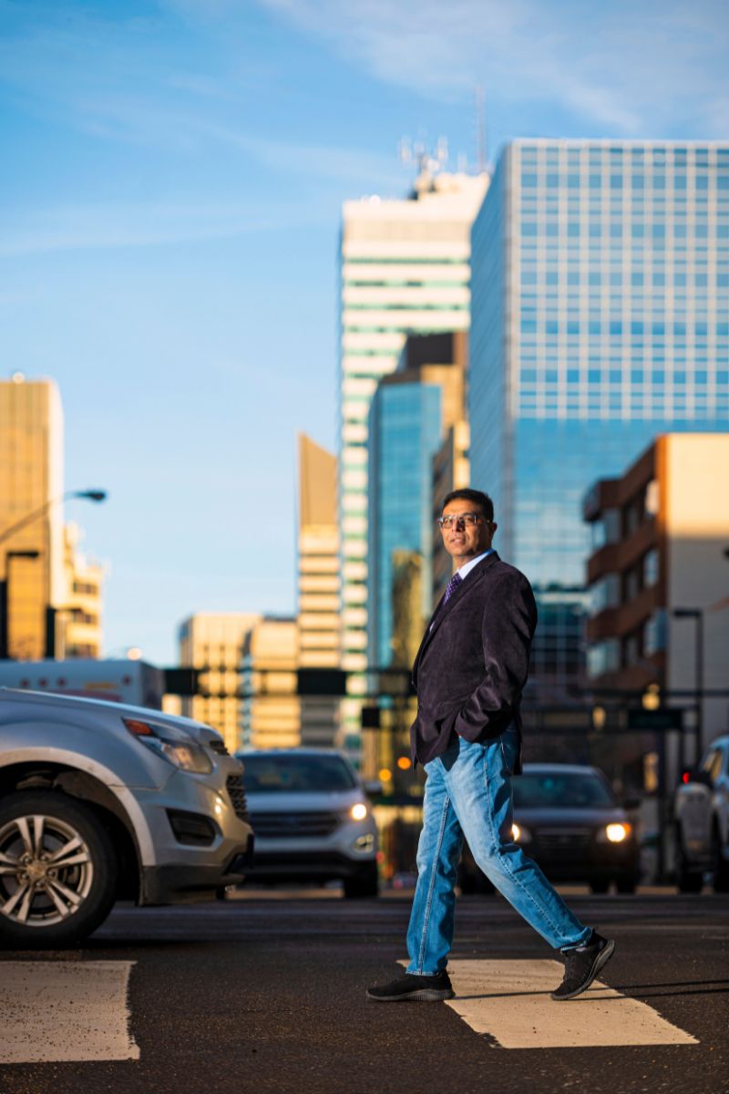 Urban planning researcher Sandeep Agrawal crosses an intersection in downtown Edmonton.