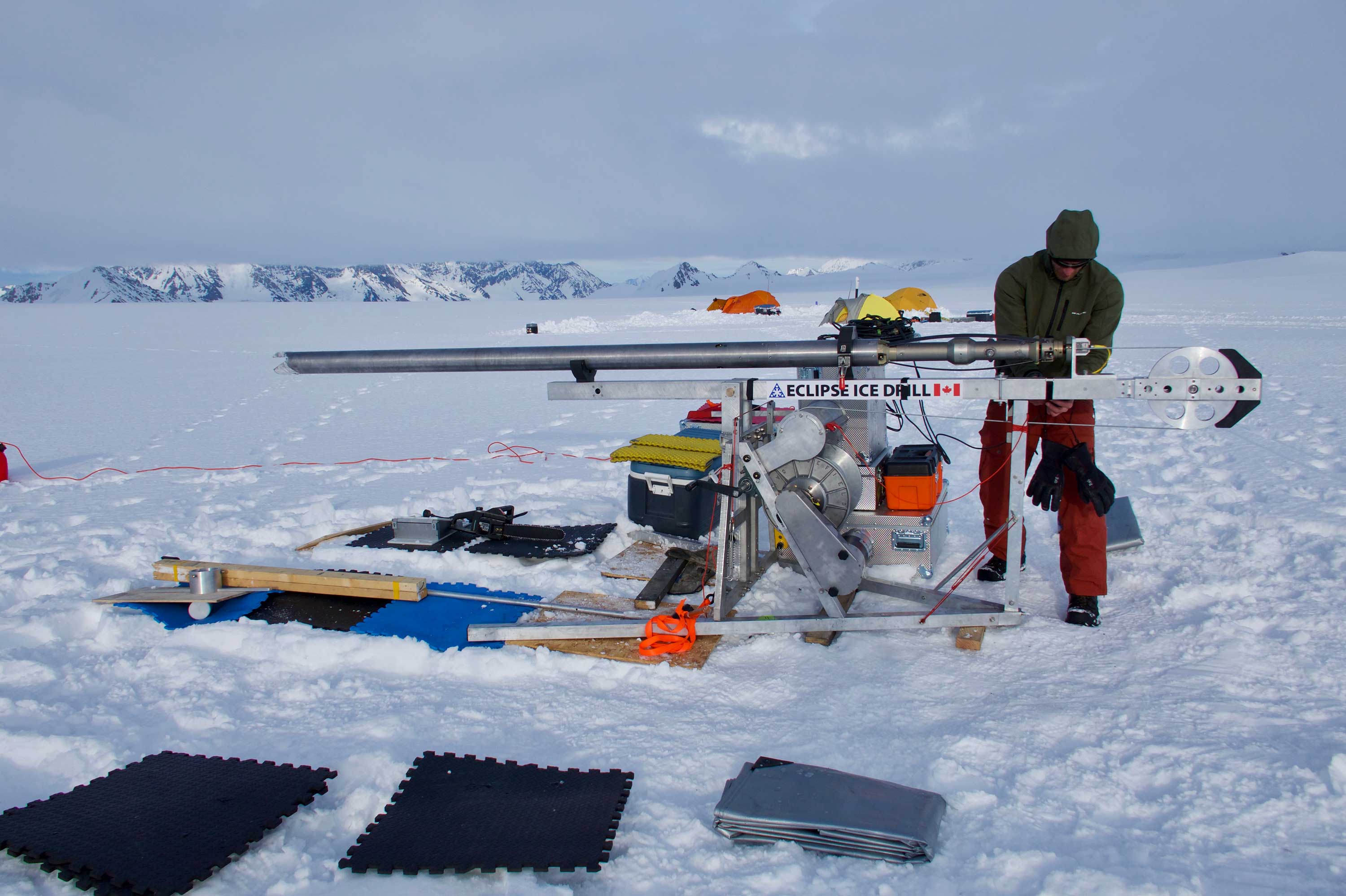 Scientist using an Eclipse ice coring drill in an icefield.