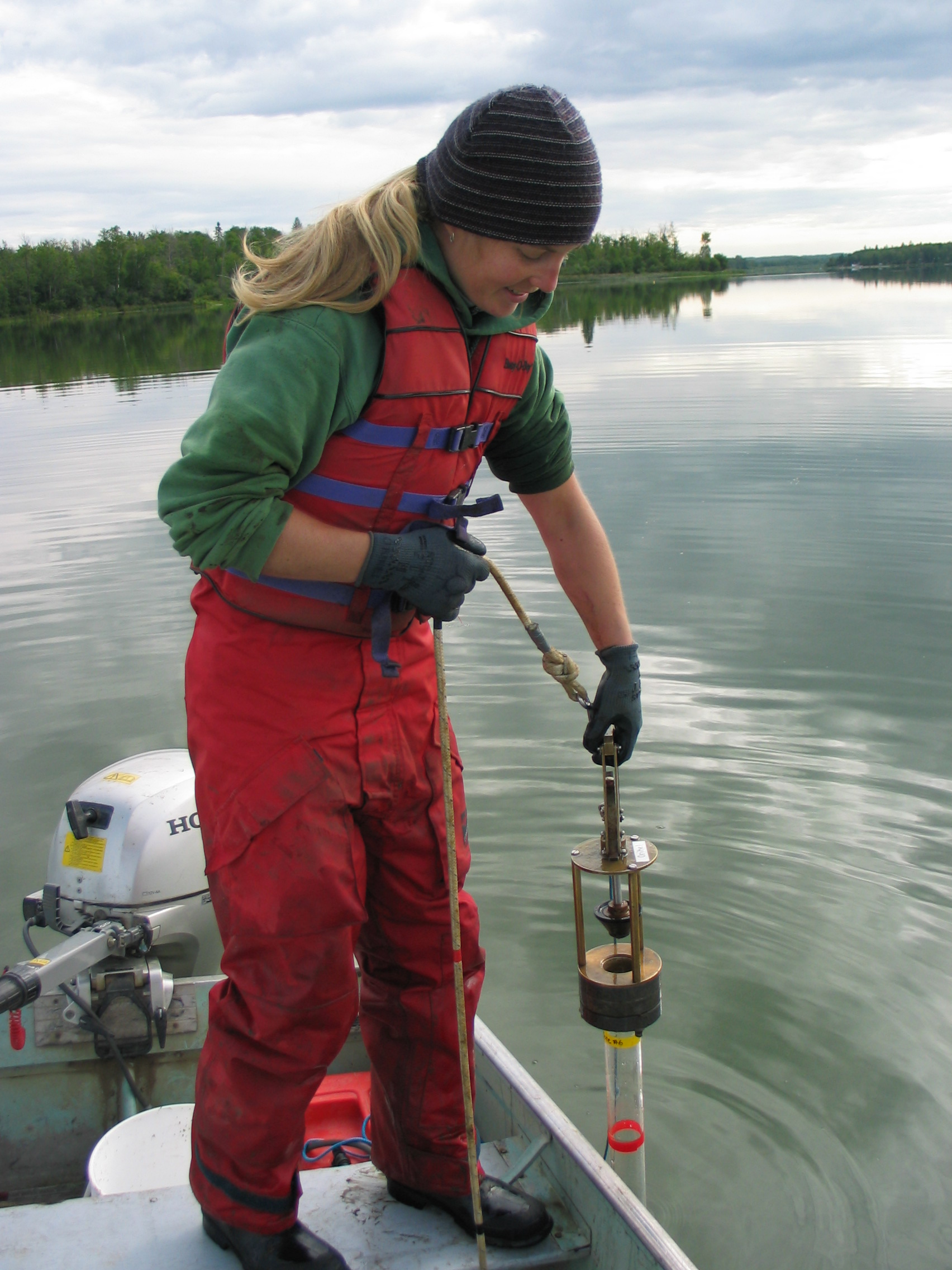 Freshwater ecologist Diane Orihel takes a lakewater sample