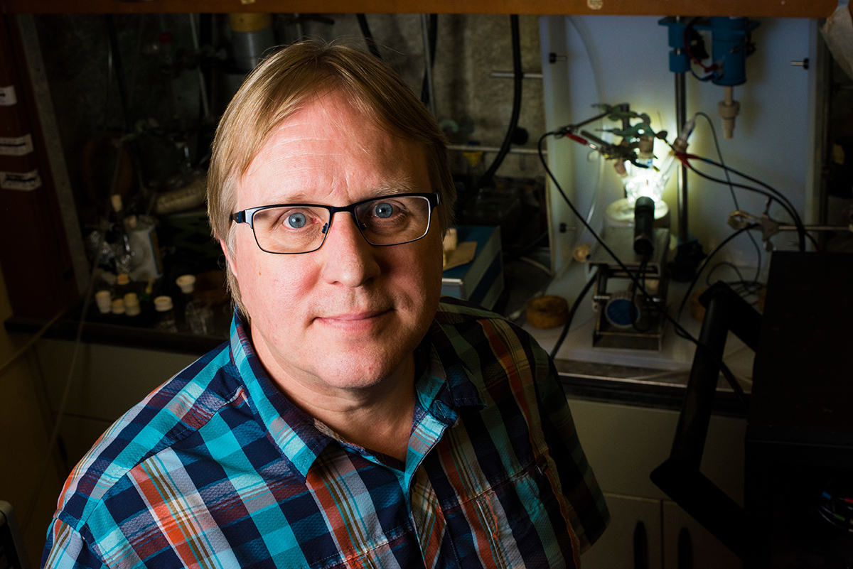 Steven Bergens, professor and chemist, is developing a catalyst that will turn carbon dioxide into useful molecules, like fuel, using light and water. Photo credit: John Ulan 