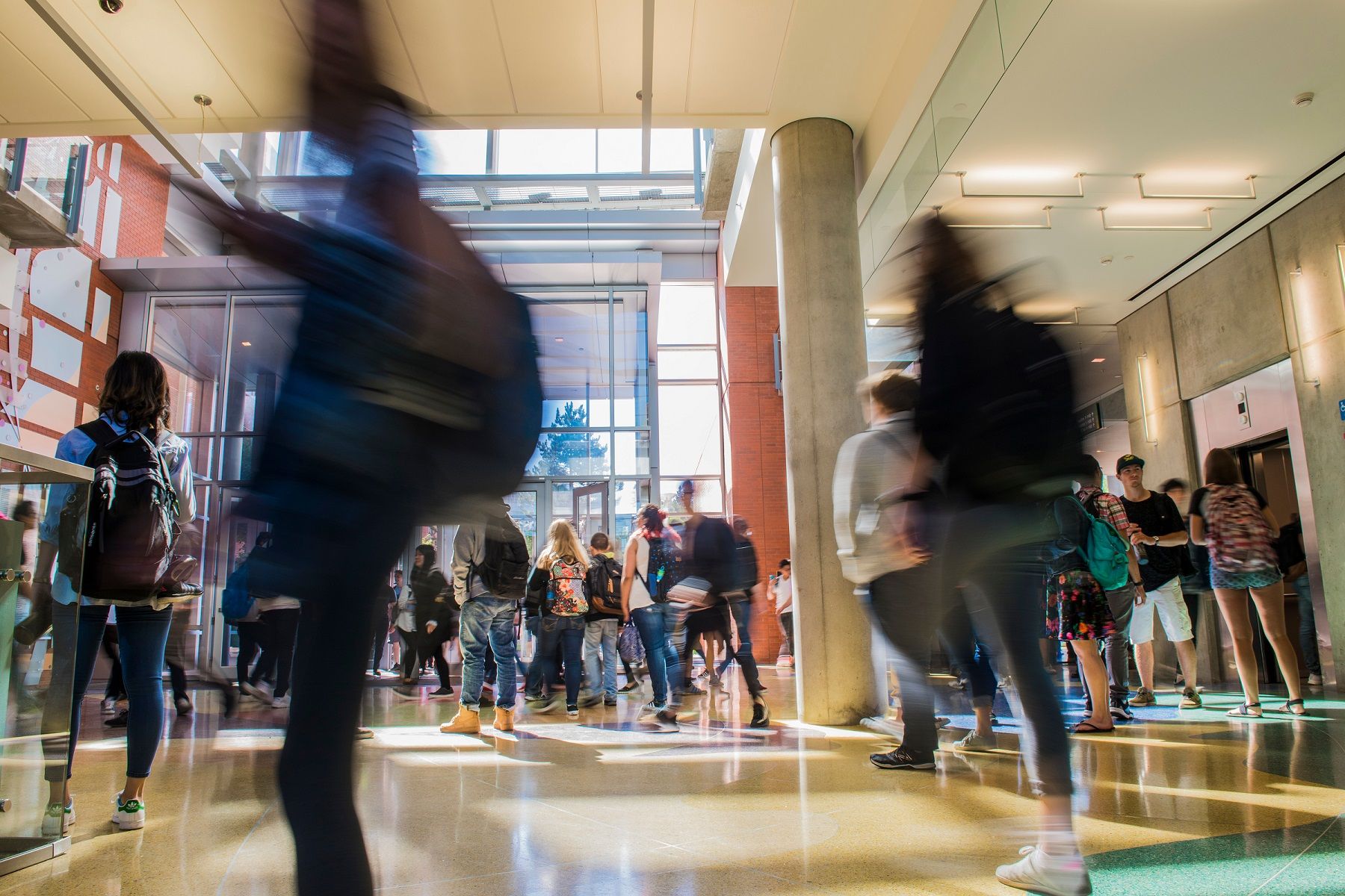 Blurred shot of students moving through CCIS between classes.