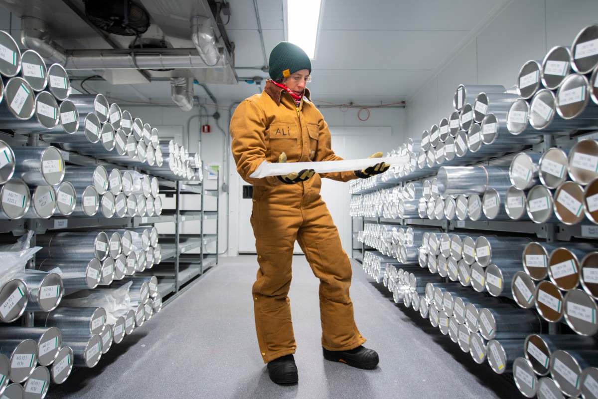 Alison Criscitiello, director of the Canadian Ice Core Lab, holds an ice core in the lab. Learn from her about the incredible science coming from beneath the ice in the third Science Connects webinar.