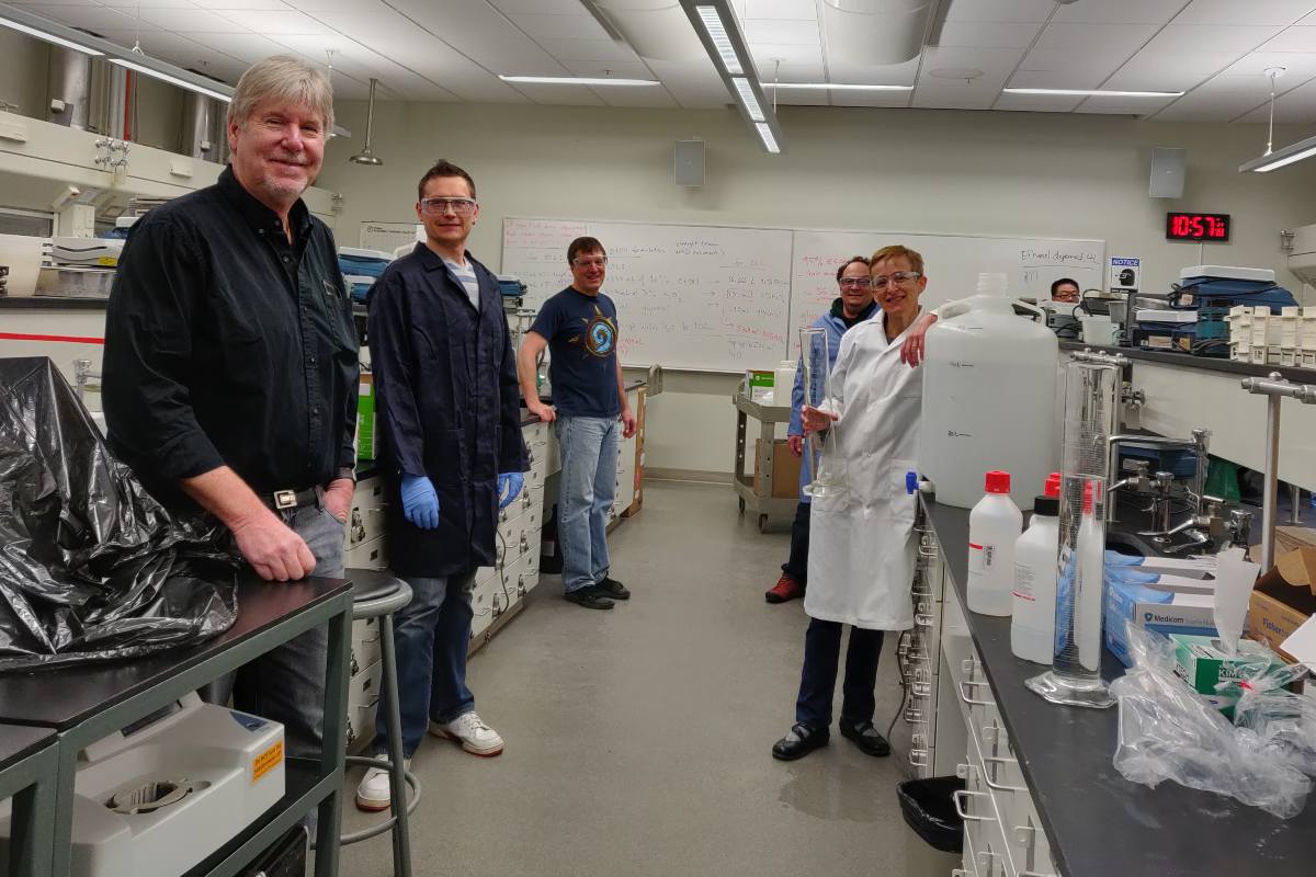Faculty from the Department of Chemistry gather in a lab, producing hand sanitizer to donate to the community.