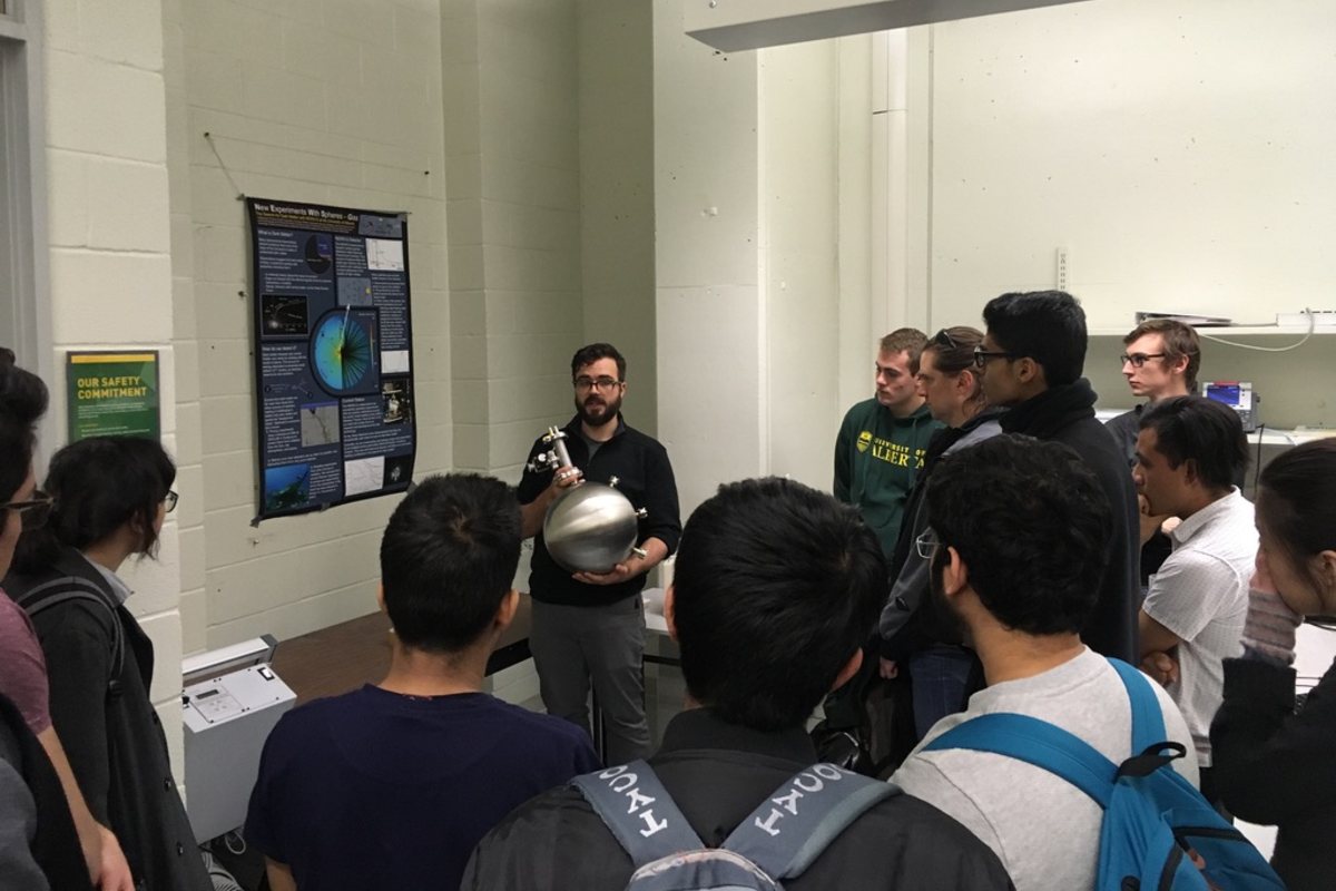 PhD student Daniel Durnford shares a physics demonstration with prospective students at Open House in 2019.