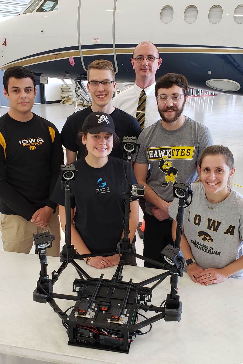 From left to right: Danny Harris, Jari Swanson, Katelyn Ball, David Miles, and Emma Rigby take a photo with the boom deployment test rig, ready for flight.