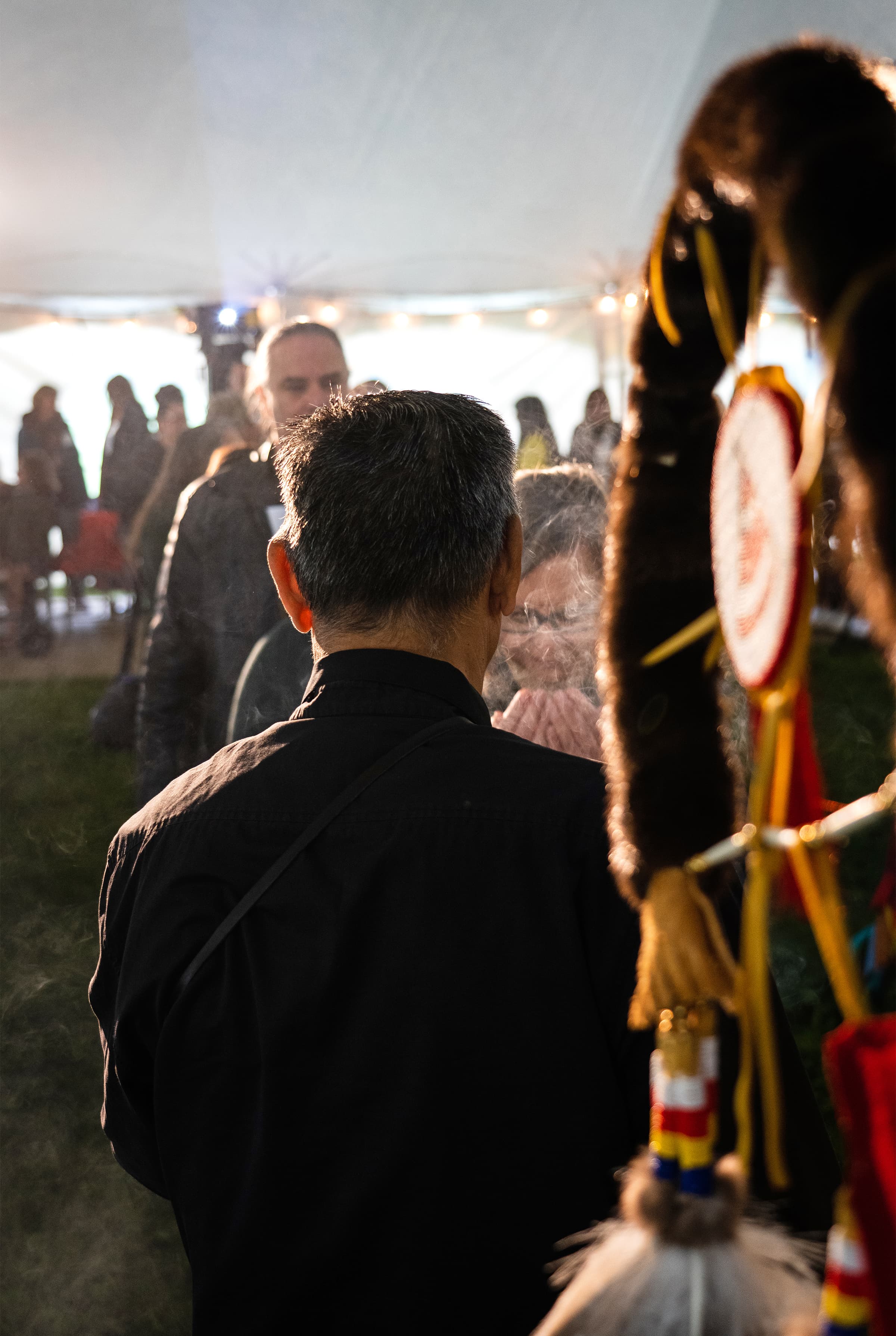  Elder Francis Whiskeyjack leads a pre-ceremony smudge beside one of the Eagle Staffs.