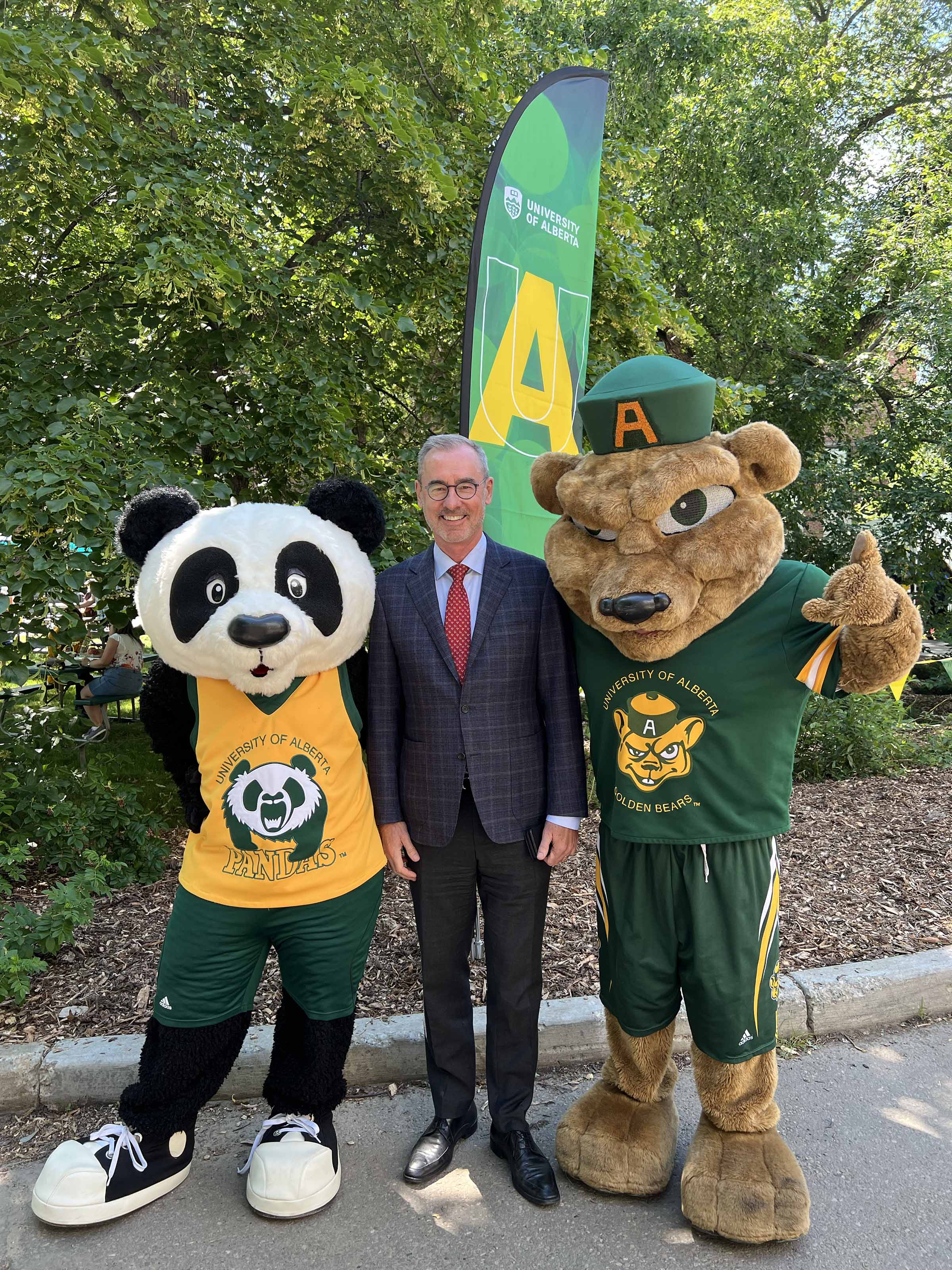 Patches and Guba pose with President Bill Flanagan.
