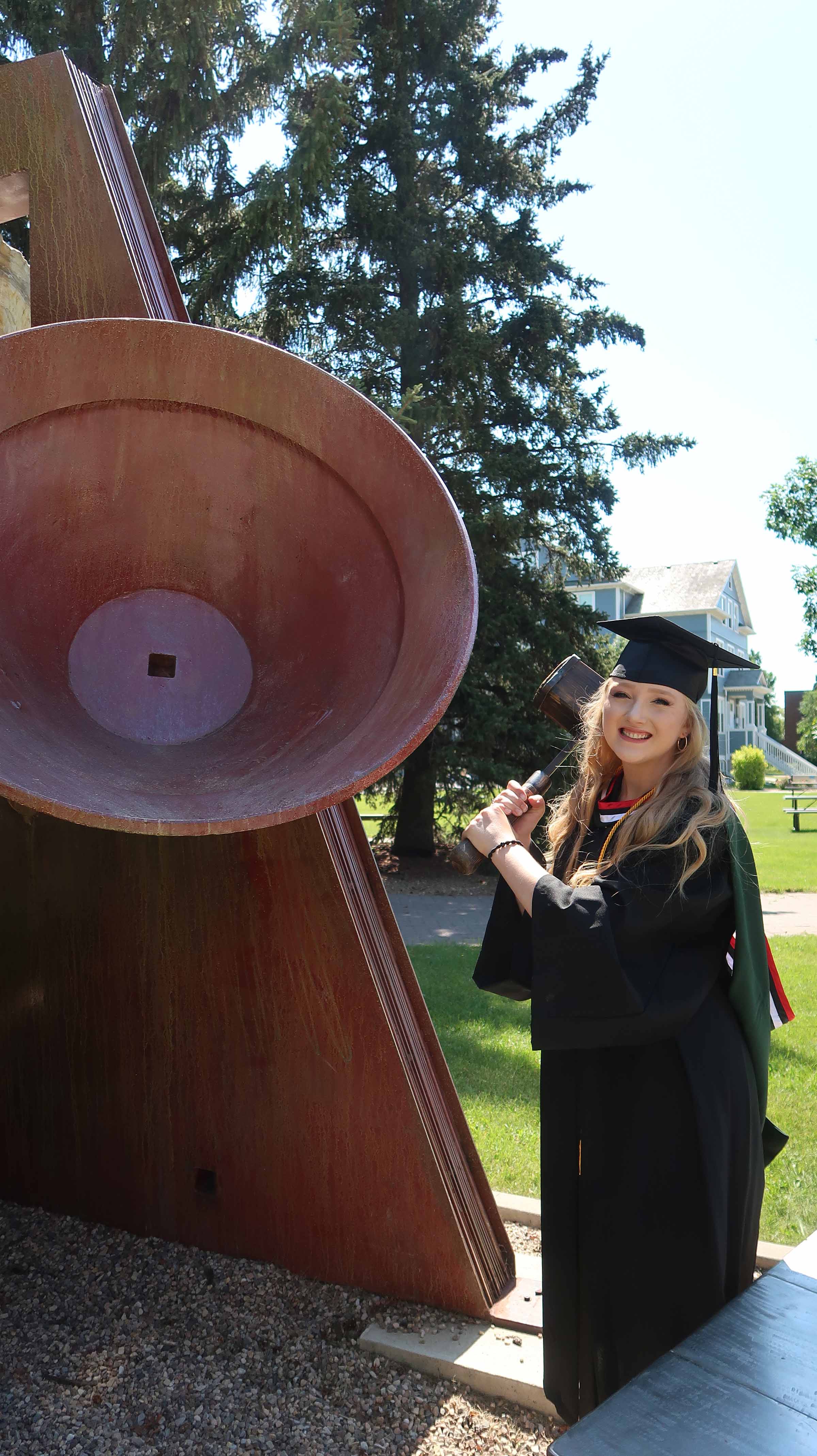 Augustana graduate Alexandra Brigley (BMus '20) ringing the Centenary Bell at Augustana (a last-day-of-classes tradition that '20 and '21 grads could finally participate in)