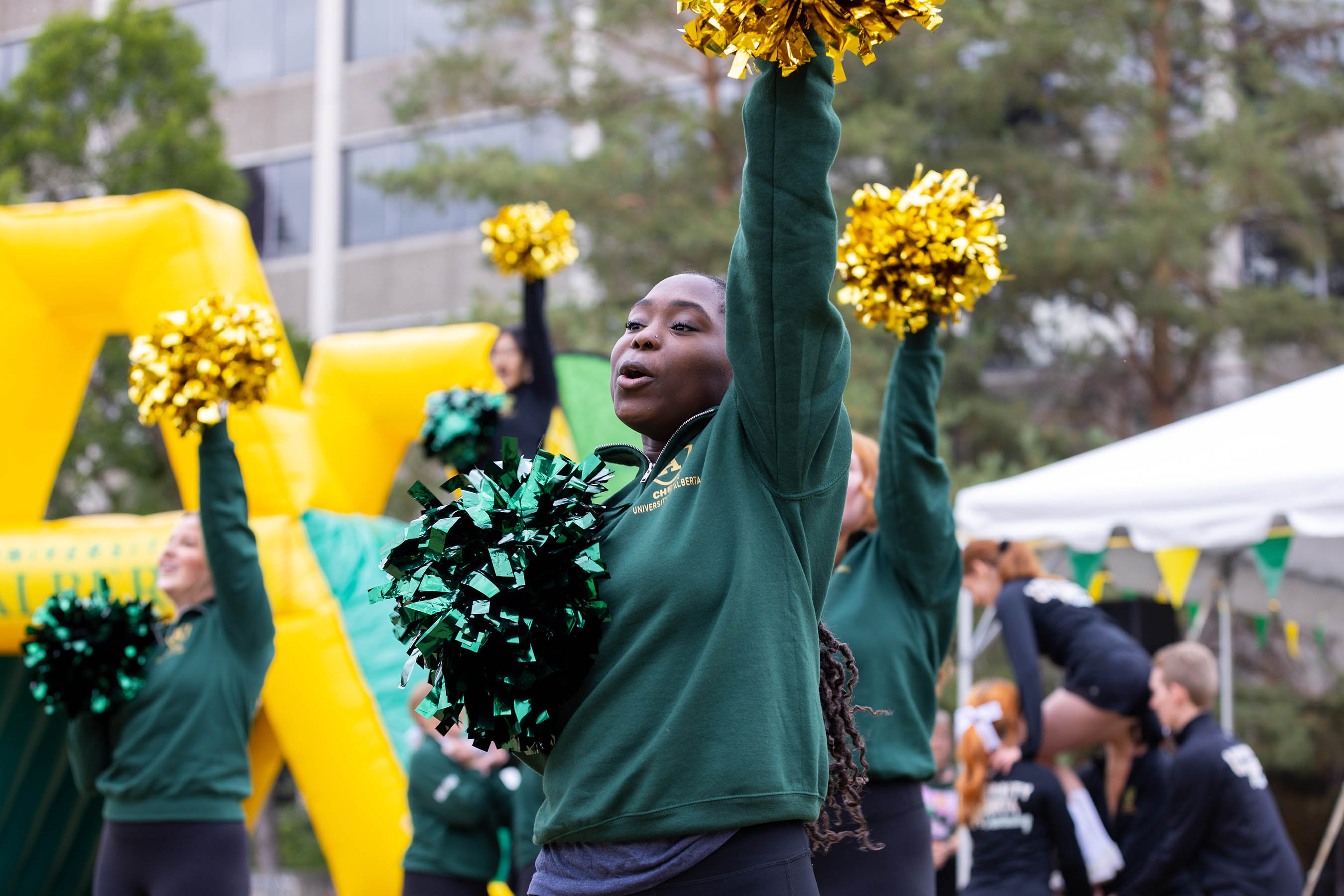 The University of Alberta Cheer team at the 2022 Green + Gold Day pep rally