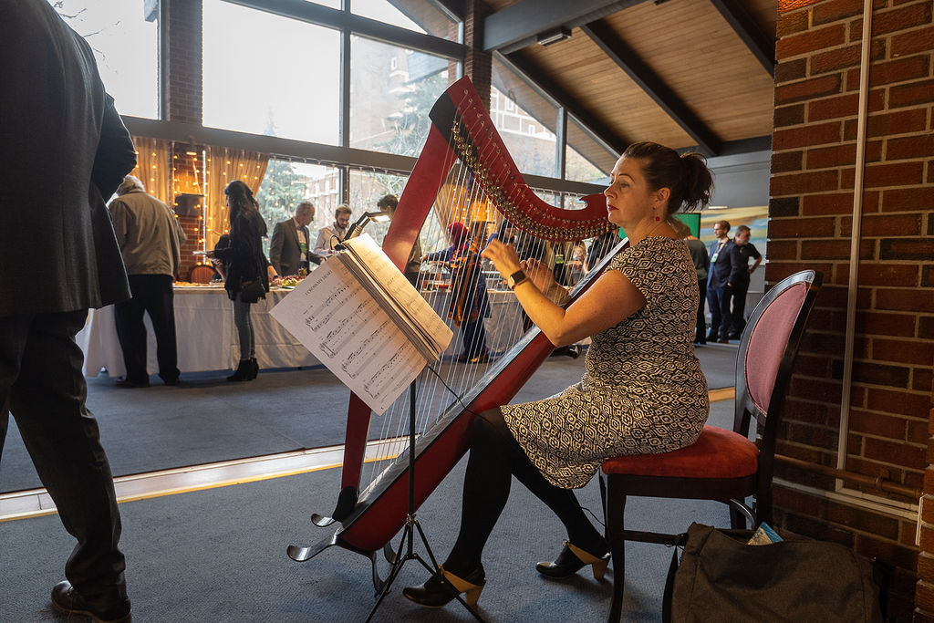 Harpist Keri Lynn Zwicker provides music for the event.