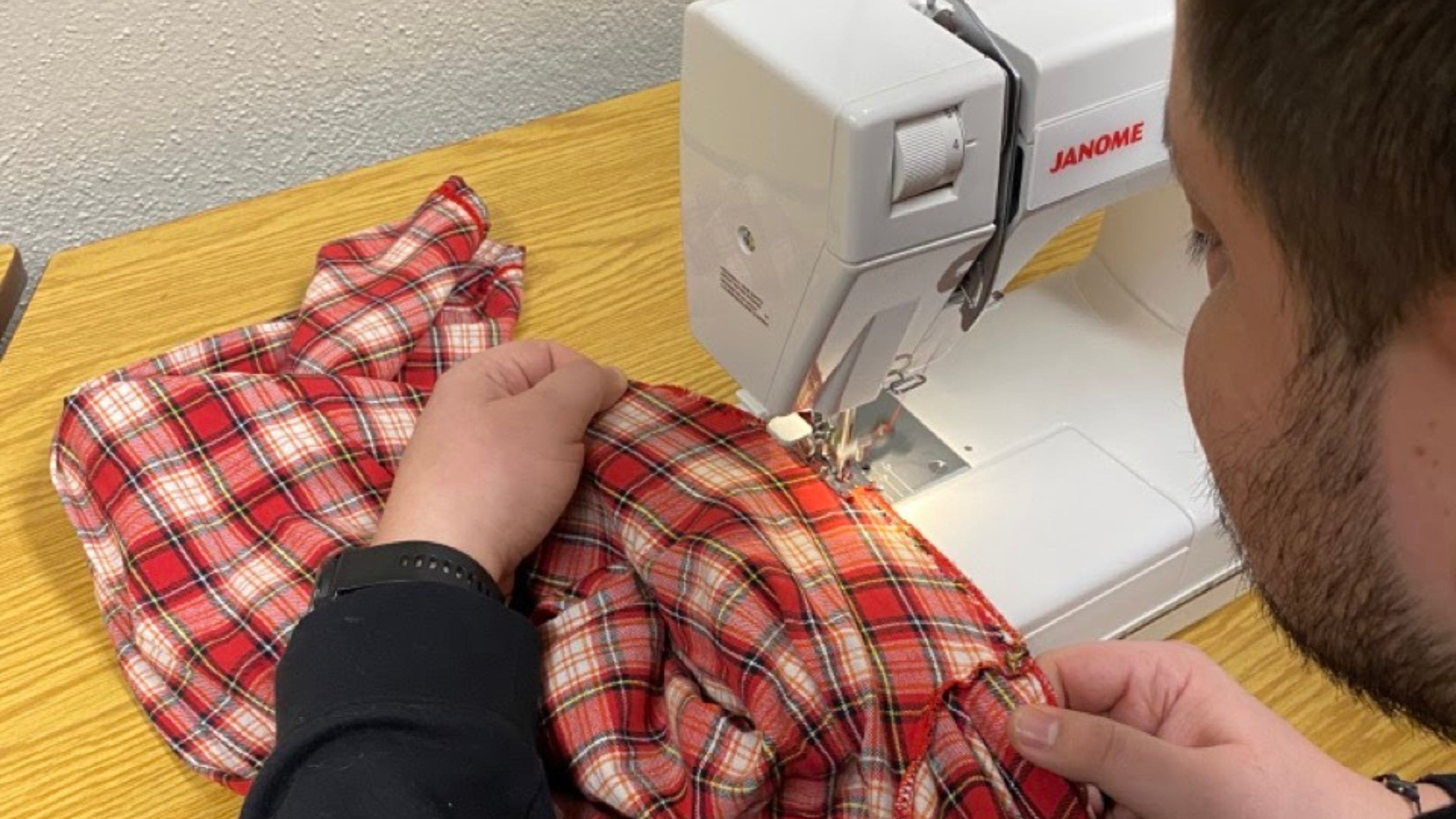 U of A community member using a sewing machine at the Repair Cafe