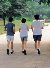 Youths jogging in park